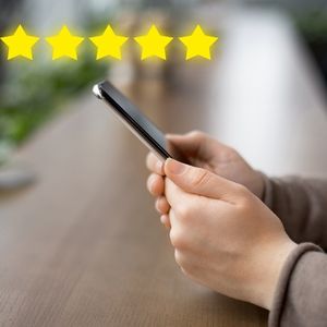 KMD Blog - woman leaving five star review on a mobile device